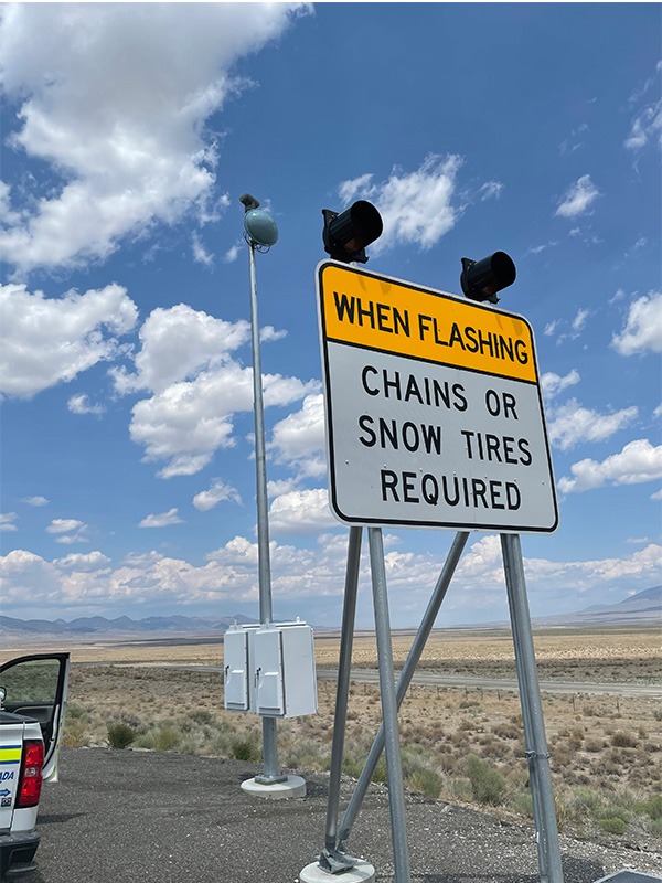 Chains or Snow Tires Required When Lights Are Flashing Sign